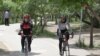 Iran -- Women on bicycle in a park Iran, Apr2011