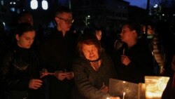Mourners light candles for victims of a fire in a night club in the town of Kocani, North Macedonia.