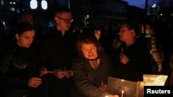 Mourners light candles for victims of a fire in a night club in the town of Kocani, North Macedonia.