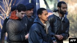 Detained U.S. nationals suspected of militancy are escorted by police upon arrival at a court in Sargodha.