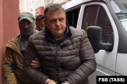 Vladyslav Yesypenko is detained by FSB officers in Crimea on March 16.