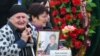 Relatives of the Kerch school-attack victims grieve at a ceremony to pay their last respects in the city center on October 19.