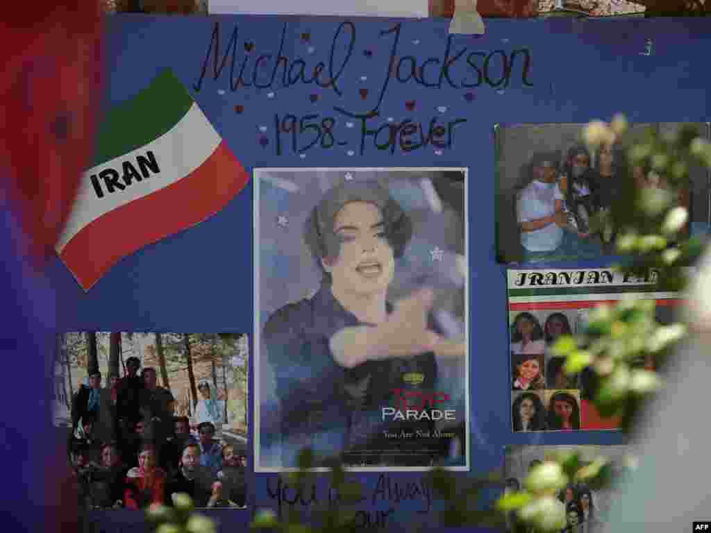 A poster made by Iranian fans adorns a makeshift shrine to pop music legend Michael Jackson outside the Jackson family compound in Encino, California. Jackson died on June 25 at the age of 50.