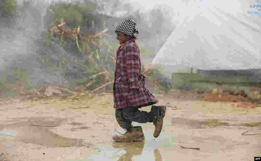 A displaced Syrian girl walks at a refugee camp in the eastern Ghouta region on the outskirts of the capital, Damascus. (AFP/Amer Almohibany)