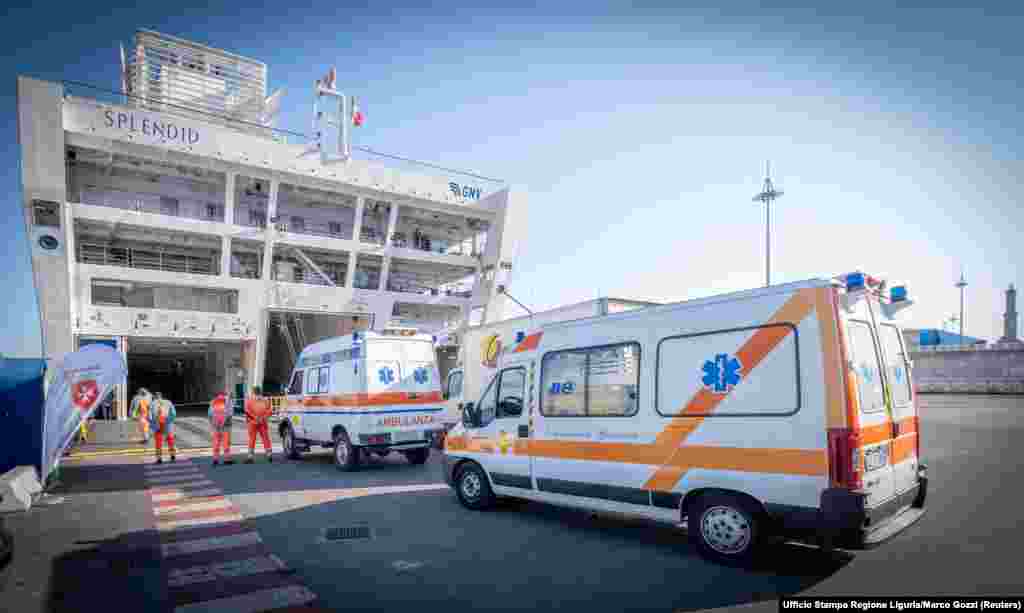 Ambulances in the port of Genoa, Italy, drive onto a passenger ship that was transformed into a hospital on March 23.