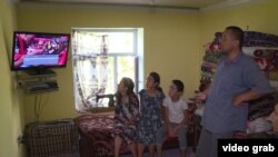 A family in Tajikistan watches television. 