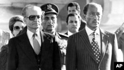 The Shah meets Anwar Sadat after landing in Egypt
