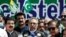 Pakistani President Arif Alvi (C) speaks, along with other leaders, during a rally organized to show their solidarity with people of Indian-administered Kashmir, on a street in Islamabad on August 5.