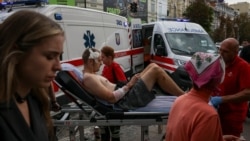 Medical workers in Kyiv evacuate a wounded man after a Russian strike on the headquarters of Ukraine's SBU security service on September 3. 