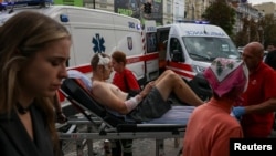 Medical workers in Kyiv evacuate a wounded man after a Russian strike on the headquarters of Ukraine's SBU security service on September 3. 