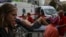 Medical workers in Kyiv evacuate a wounded man after a Russian strike on the headquarters of Ukraine's SBU security service on September 3. 