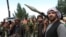 AFGHANISTAN -- Armed men attend a gathering to announce their support for Afghan security forces and that they are ready to fight against the Taliban, on the outskirts of Kabul, June 23, 2021