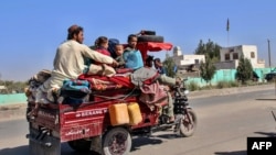 Internally displaced Afghans flee from Nadali district to Lashkar Gah in Helmand during clashes between Taliban fighters and Afghan security forces on October 14