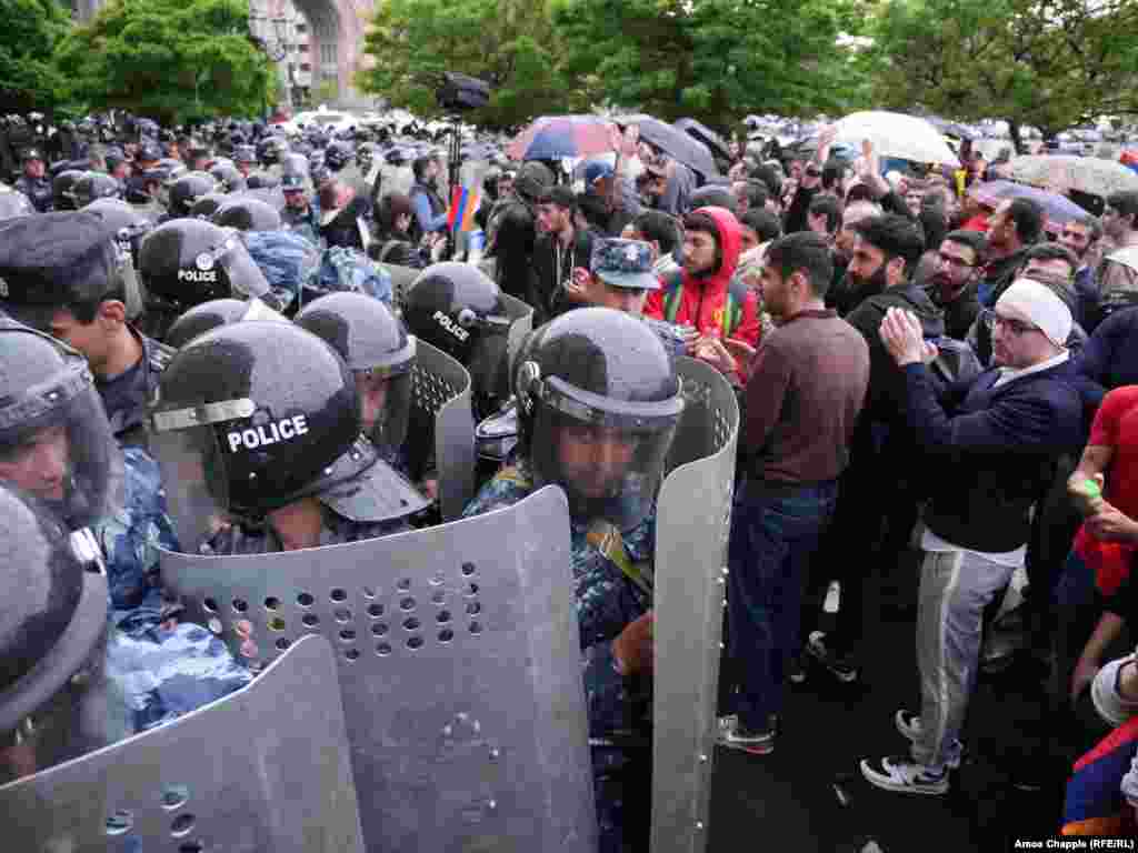 Police block the way to opposition demonstrators protesting on Republic Square in Yerevan on April 19. "Tense but weirdly good-natured atmosphere on Republic Square," photographer Amos Chapple says. "Cops smiling at protesters' jokes."