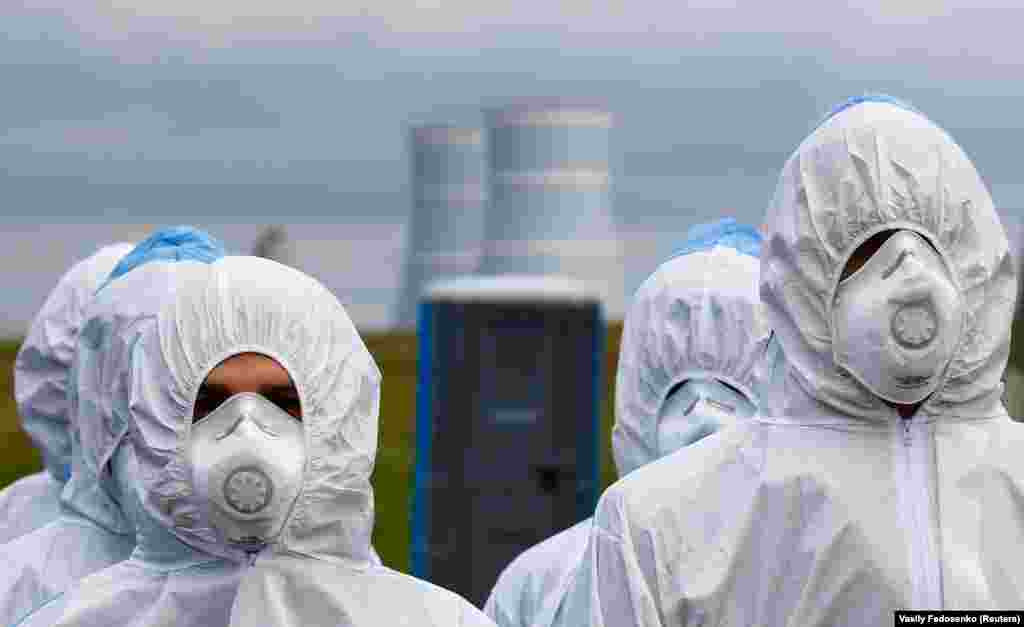 Employees of Belarus's first nuclear power plant take part in emergency services drills near the town of Ostrovets on October 11. (Reuters/Vasily Fedosenko)