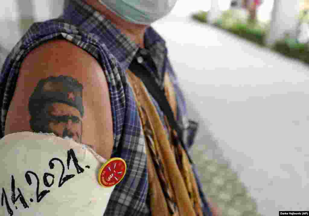 A man with a tattoo depicting former Yugoslav President Josip Broz Tito stands during a wreath-laying ceremony in Belgrade on May 4. People flocked to Tito&#39;s grave to mark the 41st anniversary of his death. (AP/Darko Vojinovic)