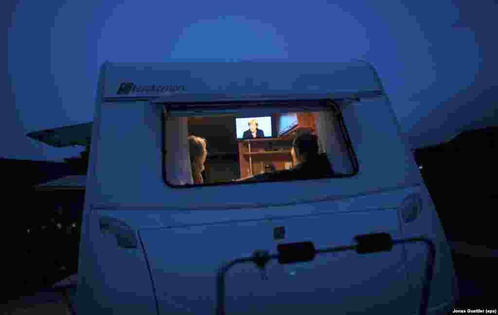 Viewers at a campground in Hagen-Vorhalle, Germany, watch a televised election debate between Chancellor Angela Merkel and challenger Peer Steinbrueck of the German Social Democratic Party on September 1.