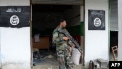 FILE: Afghan soldiers at an Islamic State (IS) office after overrunning it in Kot District of eastern Nangarhar Province.