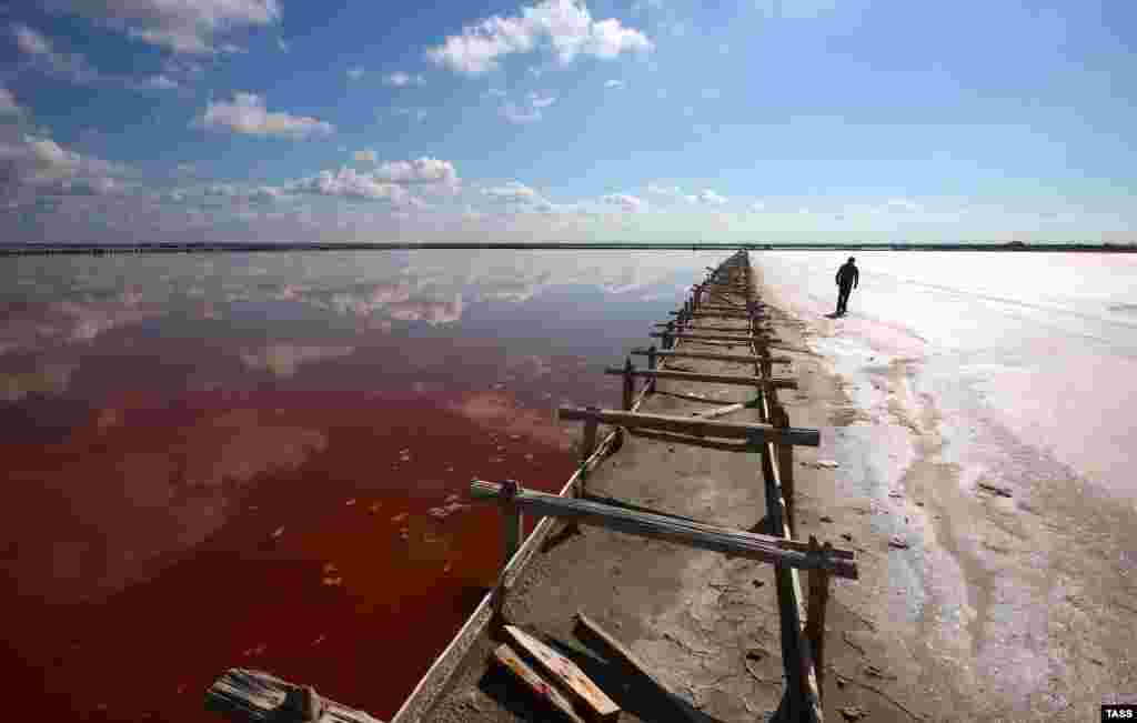 Reddish water, the product of algae rich in beta-caroteine, fills the shallow saltwater lagoon.