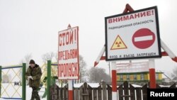 A guard exits the state radiation ecology reserve in the 30-kilometer exclusion zone around the Chornobyl nuclear reactor. Nuclear power continues to be a sensitive subject in the country.