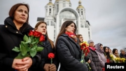 People gather to mark the fourth anniversary of the full-scale Russian invasion, in Bucha, Ukraine, on February 24.
