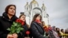 People gather to mark the fourth anniversary of the full-scale Russian invasion, in Bucha