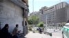 Iranian policeman looks out of the parliament's building in central Tehran during a ISIS attack on the complex on June 7, 2017