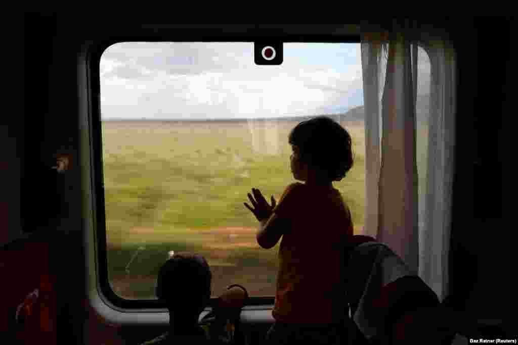 Two children look out the window as they travel on an SGR passenger train from Mombasa to Nairobi, near Tsavo East national park in Tsavo, Kenya, October 24, 2019.