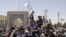 Taliban fighters hoisting the group’s flag in Kandahar, which was captured on August 12.