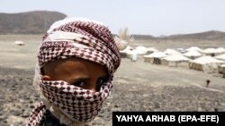 A displaced Yemeni child stands outside temporary shelters at a camp for internally displaced persons in the eastern province of Marib. The war-torn country has one of the highest numbers of people in need of humanitarian assistance according to a new report. 