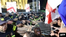 Полицейские и демонстранты у здания парламента