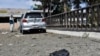 A man takes pictures at the site of a car bomb blast on an intelligence compound in Aybak, the capital of the Samangan Province on July 13.