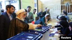 Ali Akbar Nategh-Nouri casts his vote during the presidential election in Tehran, Iran, May 19, 2017