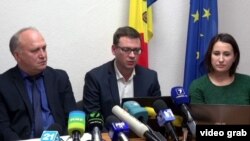 Nicolae Buzu, director adjunct al Autorităţii Aeronautice Civile (stg.), șeful departamentului de comerț al VALAN ICC Evgheni Zagrebelni (centru) și șefa departamentului de relații internaționale Cristina Grițcan (dr.) la o conferință de presă referitoare la elicopterul prăbușit în Afganistan