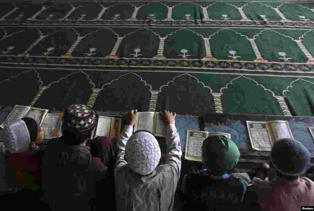 Afghan boys read the Koran in a madrasah, or religious school, during the Muslim holy month of Ramadan in Kabul. (Reuters/Omar Sobhani)