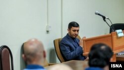 FILE - A scene from the trial of bank corruption in Iran, with the prosecutor facing the defendants.