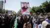 People attend the funeral of victims of the June 7 attack on June 9.