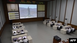 Technicians watch live images of the rocket Unha-3 at the satellite control room of the space center on the outskirts of Pyongyang.