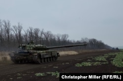 Ukrainian tanks rumble back to their base after recent training exercises in eastern Ukraine.