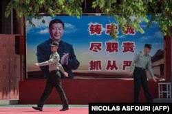 Китайський військовий біля плакату з зображенням президента Сі Цзінпіня. Пекін, 18 травня 2020 року
