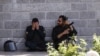 A member of the Iranian security forces reacts during a pause in the response to the Islamic State attack on the Iranian parliament.