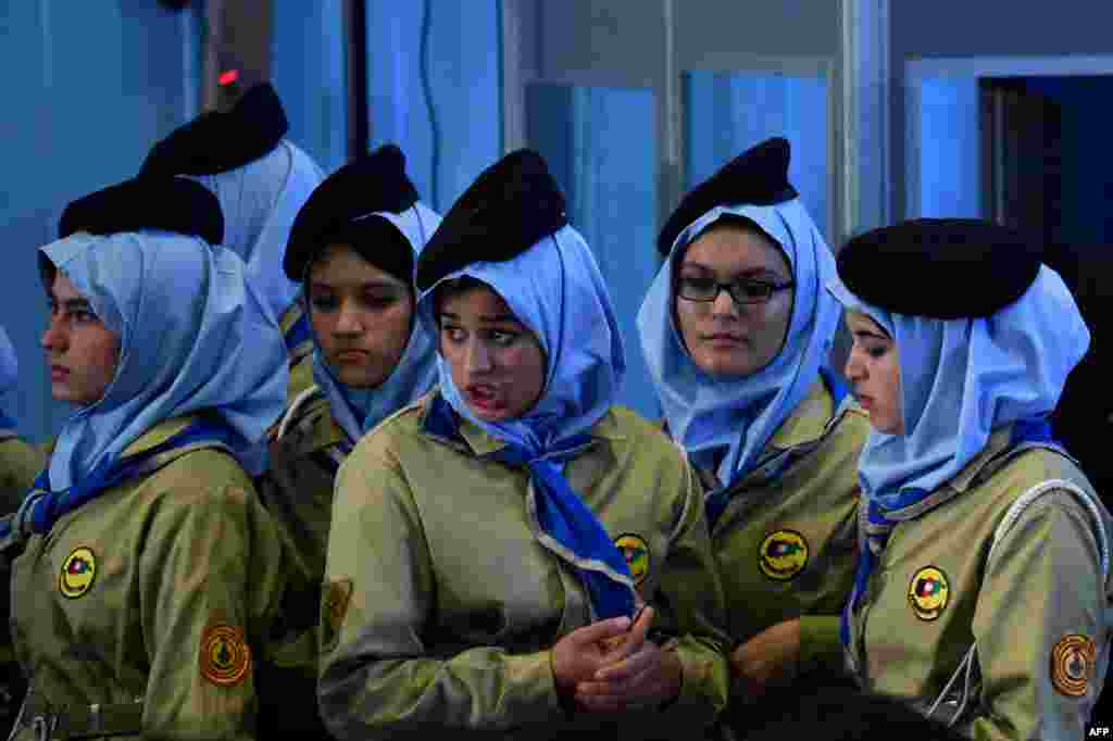 Female Afghan students look on during a ceremony marking the start of the new school year at Amani High School in Kabul on March 19. (AFP/Wakil Kohsar)