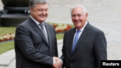 Ukrainian President Petro Poroshenko (left) and U.S. Secretary of State Rex Tillerson shake hands in Kyiv on July 9. 