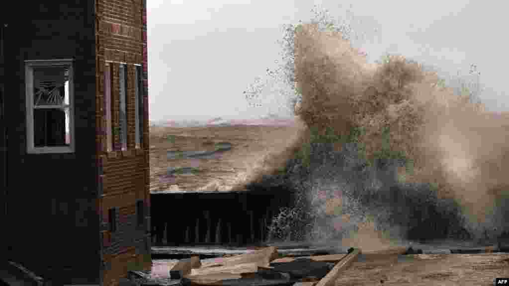 Waves break next to an apartment building in Atlantic City, New Jersey.