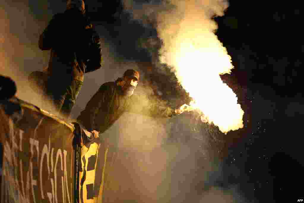 A Bosnian fan reacts with a fumigen after the second goal for Egypt during an international friendly football match between Bosnia-Herzegovina and Egypt in Innsbruck. (AFP/Pierre Teyssot)