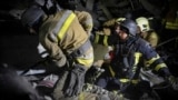 Ukrainian rescuers unblock the body of a civilian killed by a Russian drone attack in Mykolayiv, Ukraine on January 29.