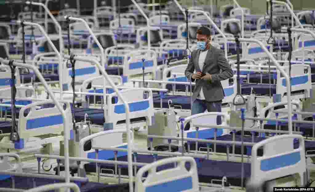 A man walks among medical beds in a coronavirus field hospital that the Georgian government has opened at the Digomi Olympic Village in Tbilisi.&nbsp;