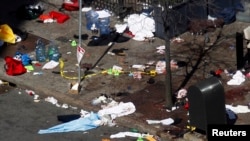 Blood and debris are seen on the sidewalk along Boylston Street on April 16, a day after two explosions at the Boston Marathon in Boston.