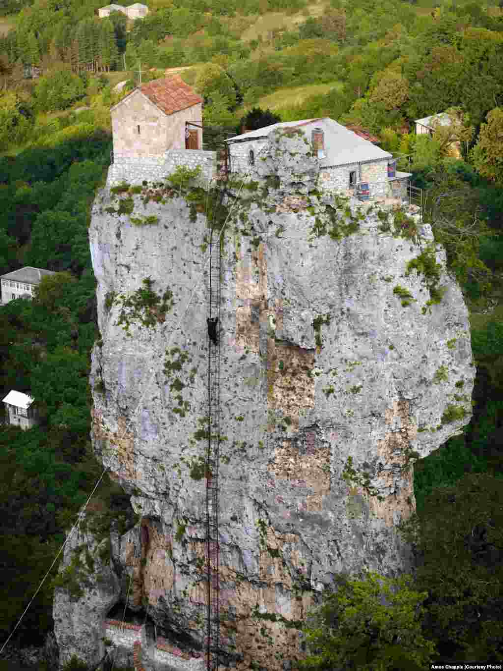 Maxime climbs the pillar after a night's prayers with the other residents of the monastery. It takes him about 20 minutes to ascend the pillar. Once he is too old to climb the ladder he will remain at the top until he dies.