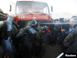 Kosovo Force (KFOR) troops employ tear gas against protesters trying to prevent the barricades from being dismantled in Jagnjenica near Zubin Potok on October 20.